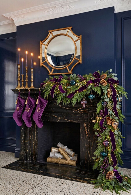 Purple and navy blue Christmas decor on a mantel
