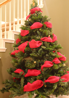The barber pole tuck method for applying ribbon garland to a Christmas tree