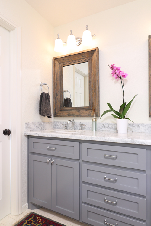 gray painted vanity marble countertop chrome faucet wood mirror